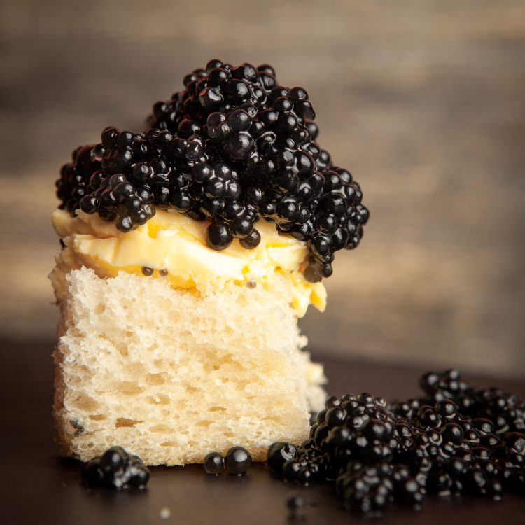 side view black caviar with butter bread dark background scaled 1