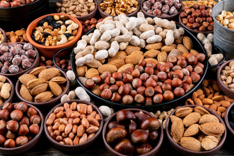 set pecan pistachios almond peanut cashew pine nuts assorted nuts dried fruits different bowls side view 2