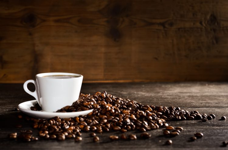 cup coffee with pile coffee beans