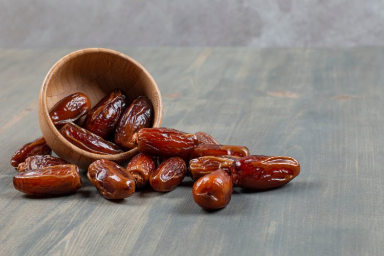 sweet dates out wooden bowl marble surface