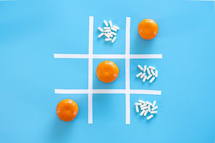 tangerines pills blue background flat lay