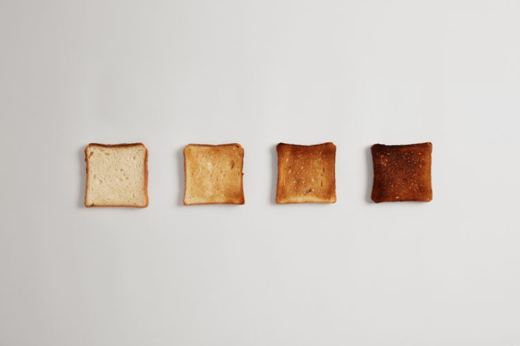 four bread slices from untoasted burnt prepared toaster arranged row against white surface set toast bread pieces making delicious crusty sandwich yummy breakfast cooking food
